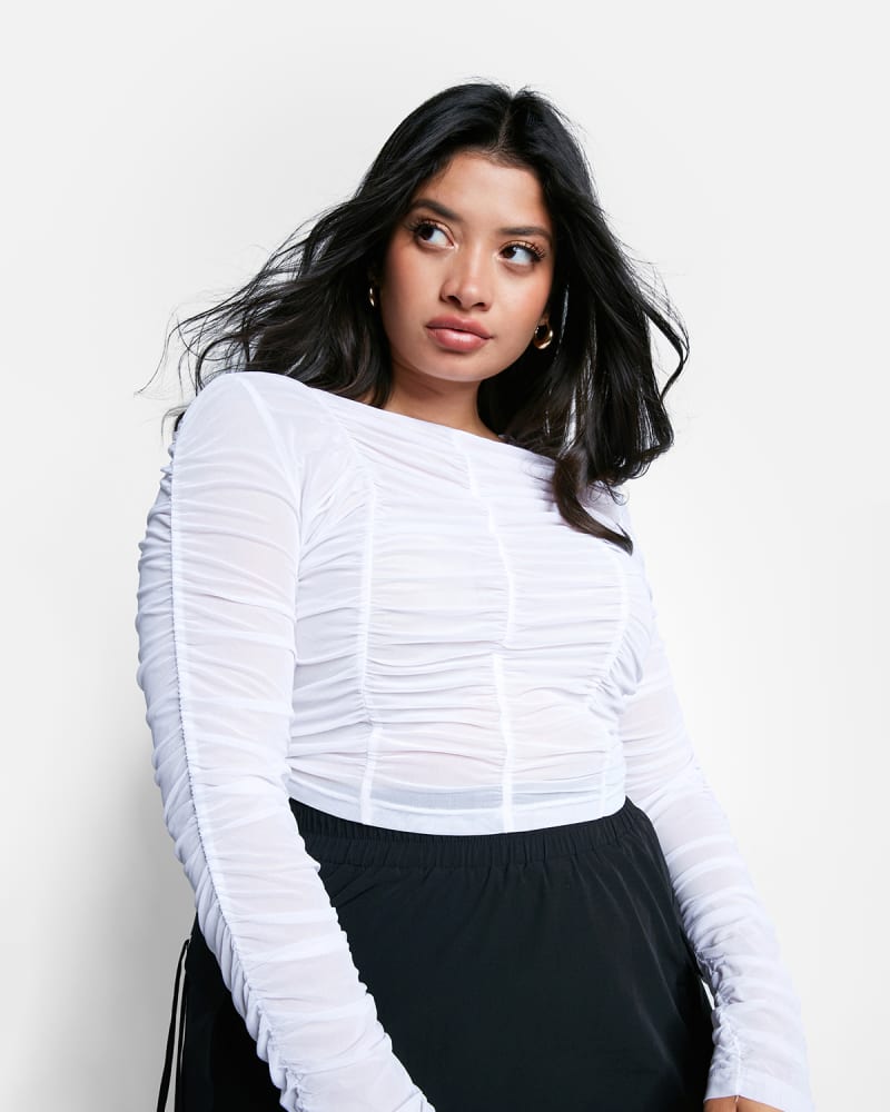 Front of a model wearing a size 1X Kai Sheer Mesh Ruched Top in White by Rebdolls. | dia_product_style_image_id:325375